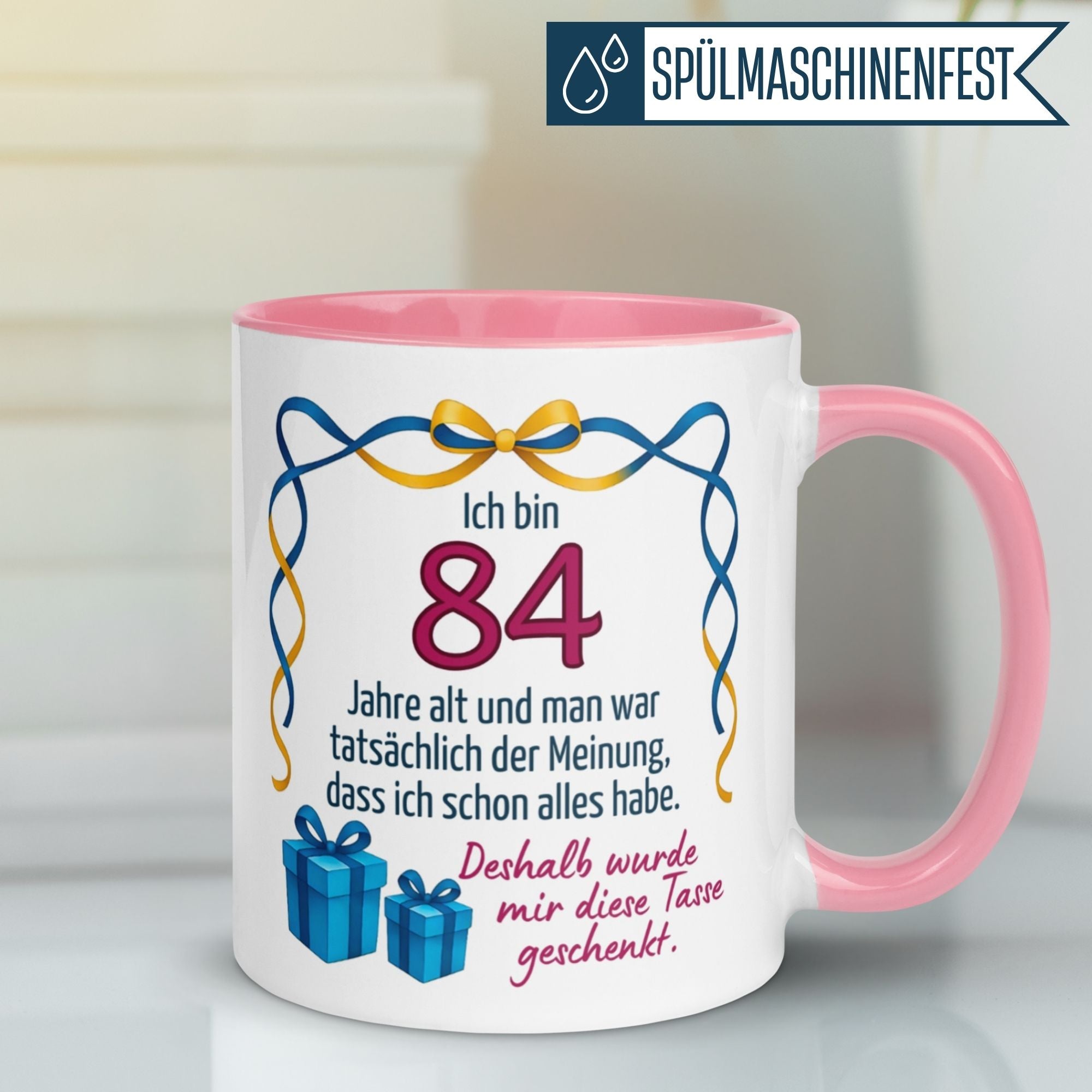 Momentals® Tasse für den 84. Geburtstag mit humorvollem Spruch und bunten Geschenken.