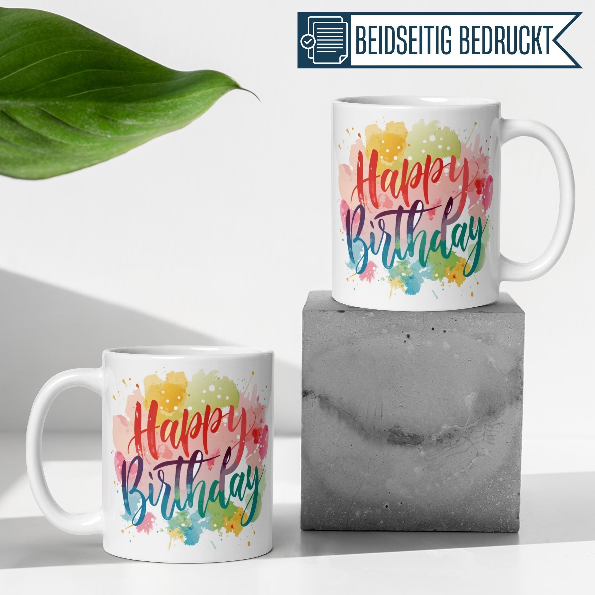 Momentals® Happy Birthday Tasse mit bunten Aquarell-Flecken für fröhliche Geburtstagsfeiern.