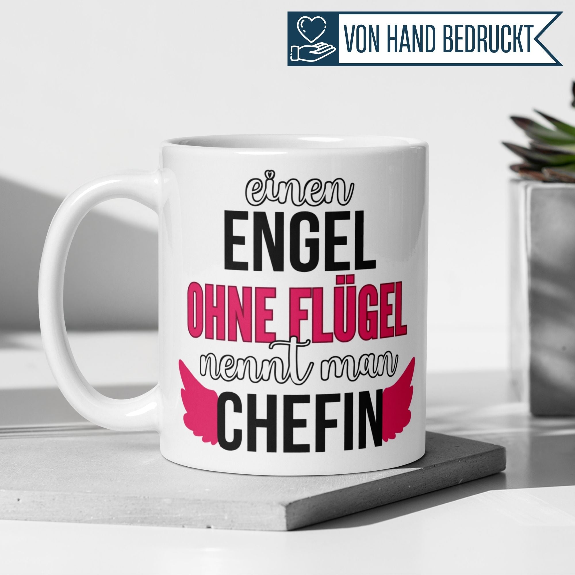 Momentals Tasse mit Spruch "Einen Engel ohne Flügel nennt man Chefin" in modernem Design mit pinken Flügeln.