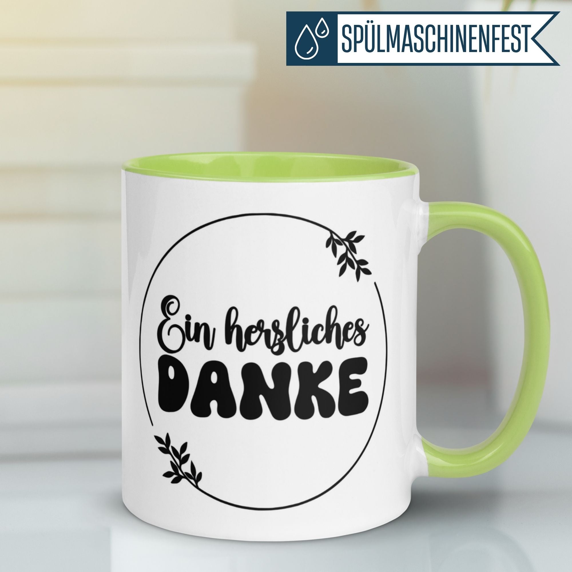 Momentals® Tasse mit Aufschrift 'Ein herzliches DANKE' und blättrigem Motiv in grünem Farbton.