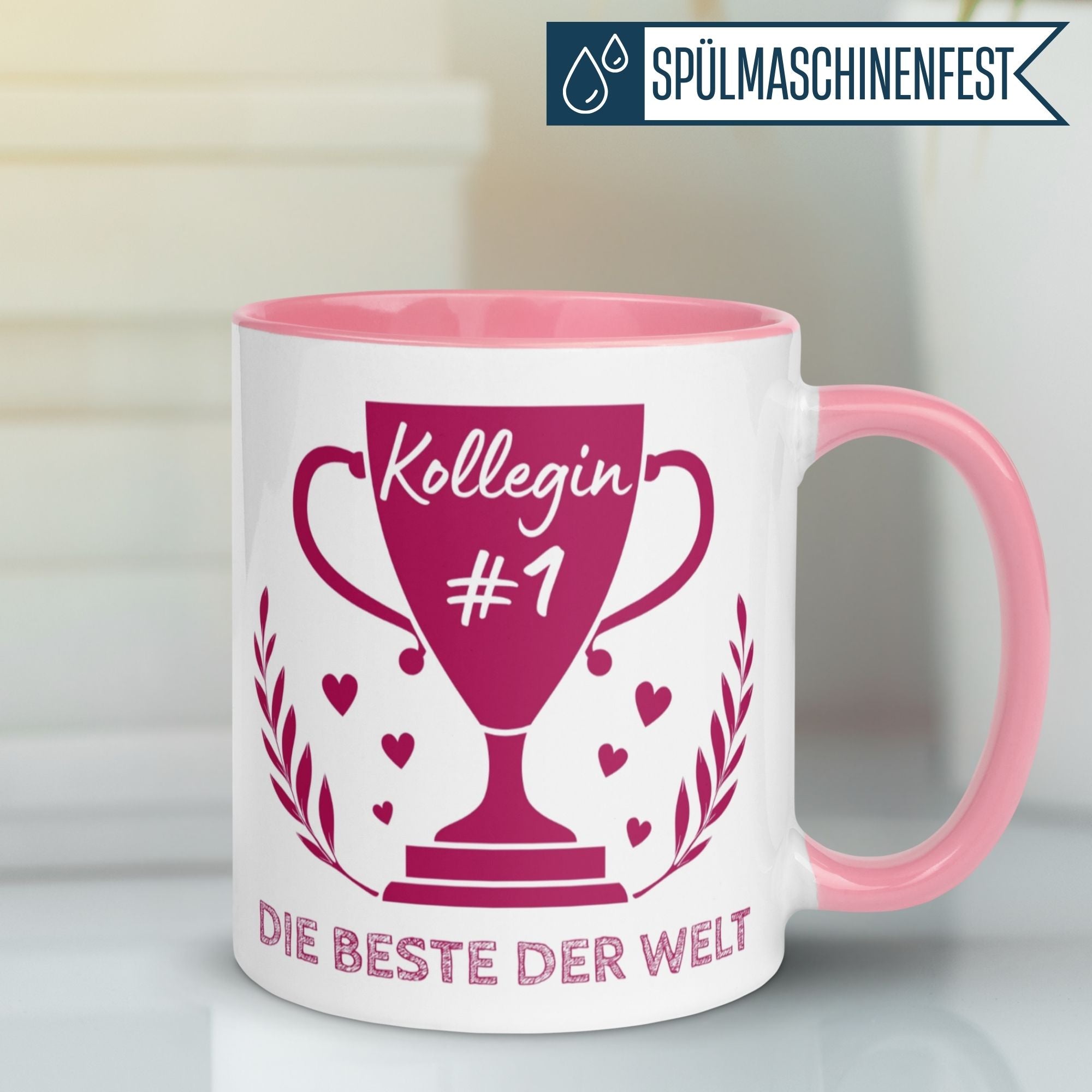 Momentals® Tasse Kollegin mit Pokal und Spruch "Kollegin #1 – Die Beste der Welt" in Pink.