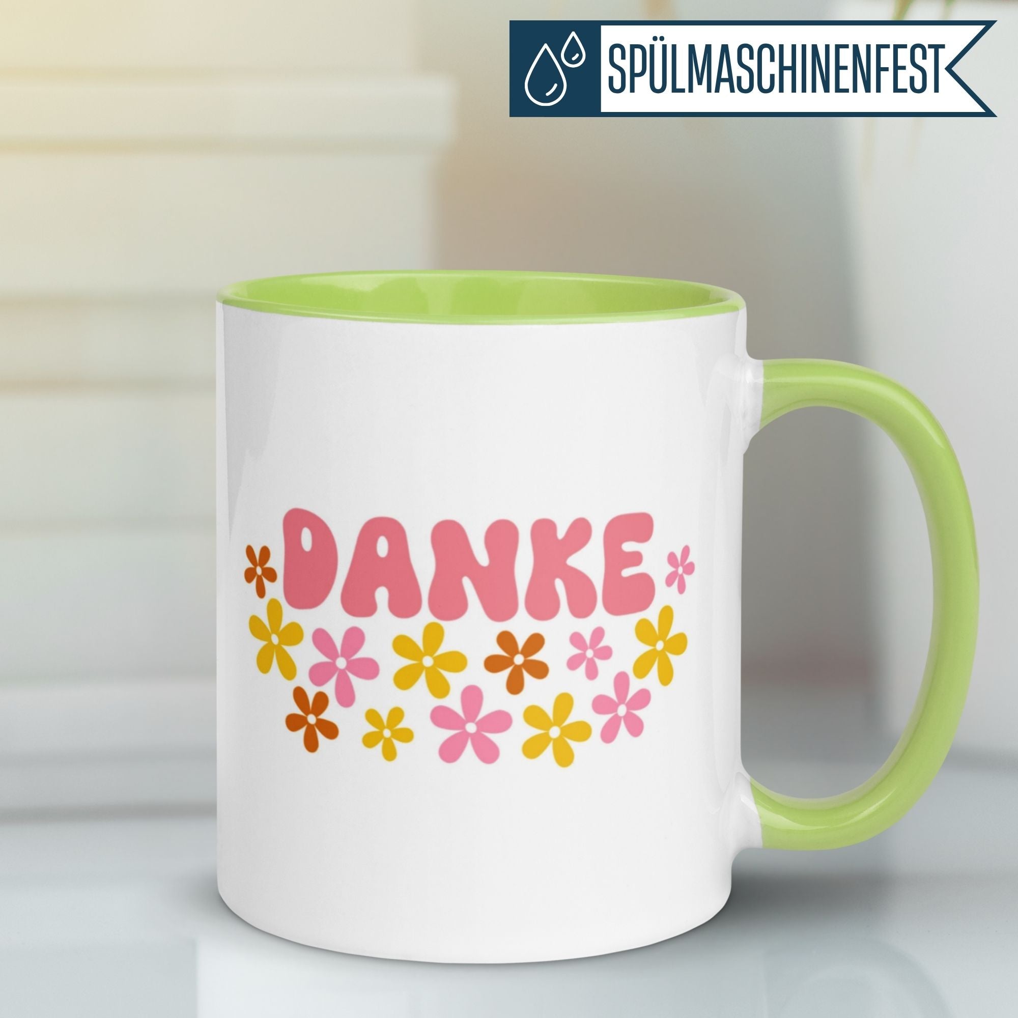 Momentals Tasse mit "DANKE" Schriftzug und buntem Blumenmuster in Flower Power Stil.