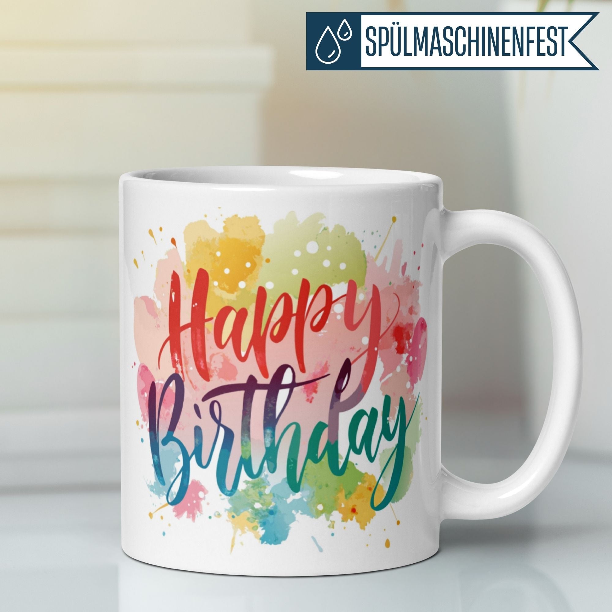 Bunte Tasse mit "Happy Birthday" Schriftzug und Aquarell-Fleckendesign, ideal als Geburtstagsgeschenk.