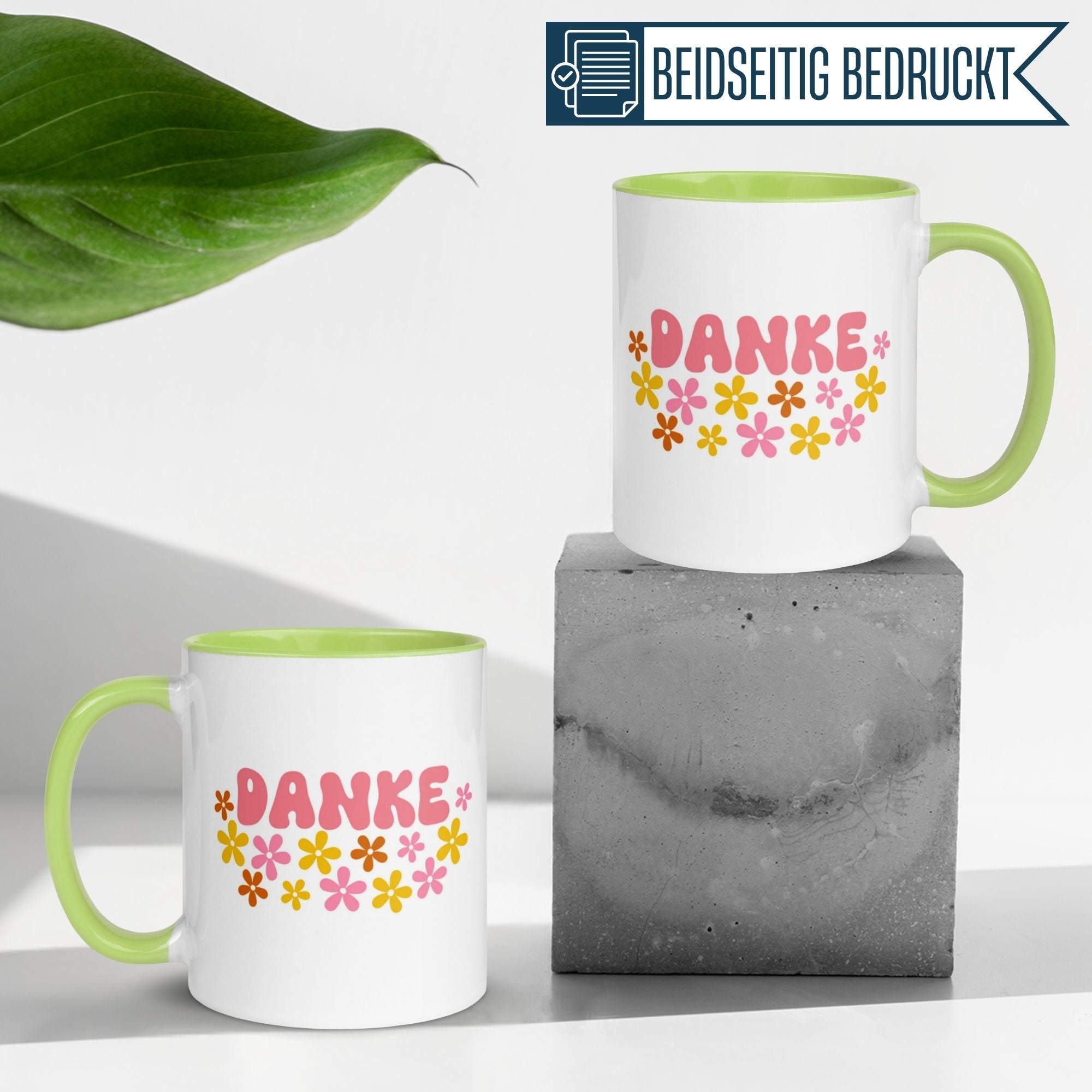 Momentals Tasse Dankeschön mit buntem Blumenmotiv und dem Schriftzug 'DANKE' auf grauem Hintergrund.