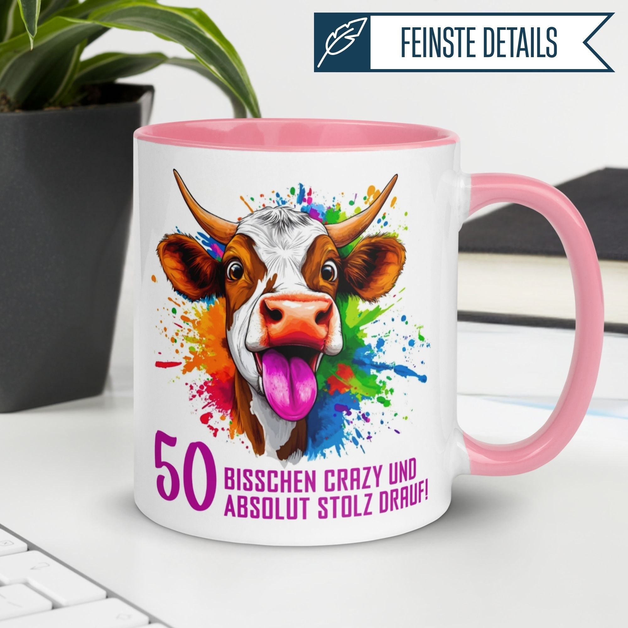 Bunte Tasse zum 50. Geburtstag mit Kuh-Motiv und Spruch: "Bisschen crazy und absolut stolz drauf!"