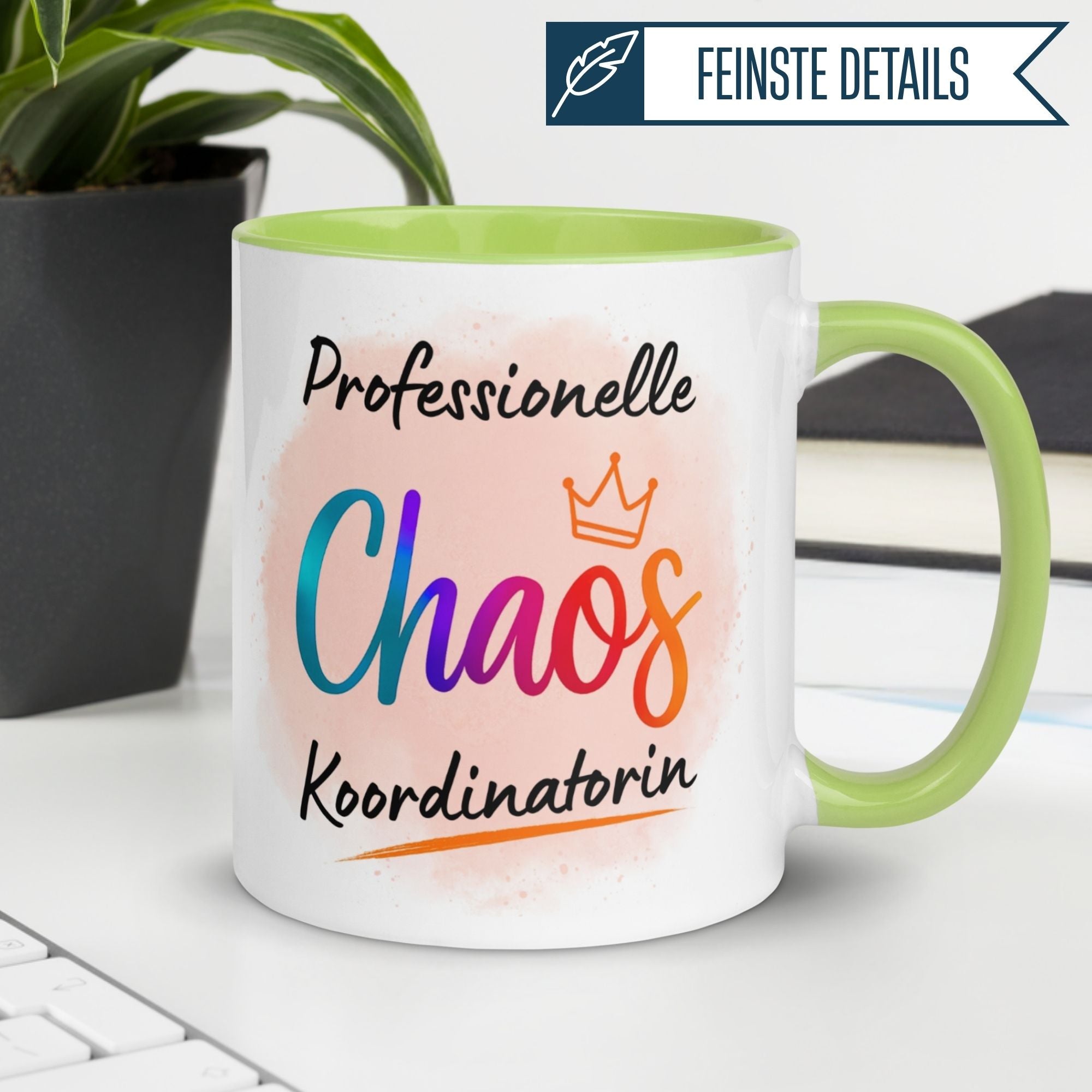 Momentals Tasse mit Spruch "Professionelle Chaos Koordinatorin" und bunter Krone auf grünem Henkel.