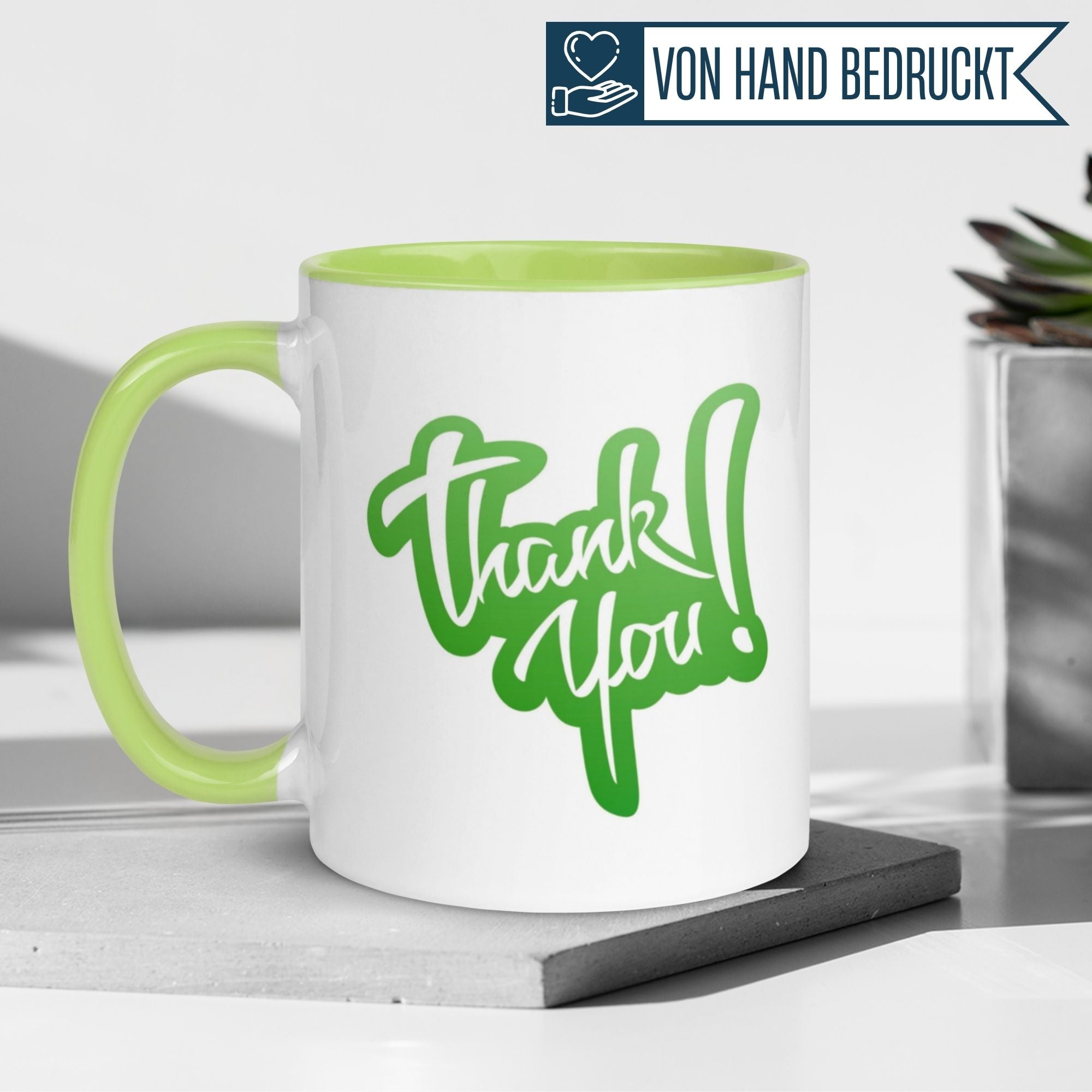 Momentals Tasse Dankeschön mit grüner Schrift "Thank You!" auf weißem Hintergrund.