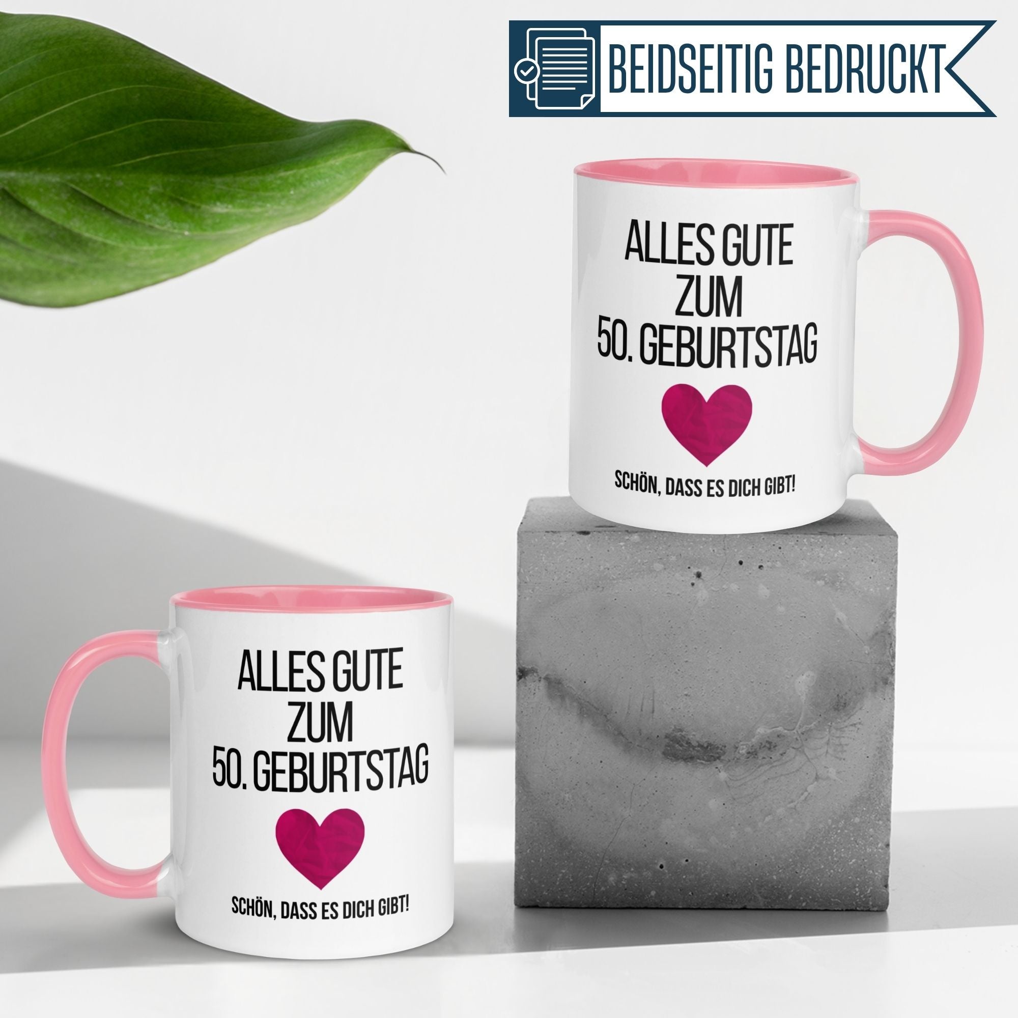 Momentals® Geburtstagstasse zum 50. Geburtstag mit Herzmotiv, pinkem Henkel und liebevollem Spruch.