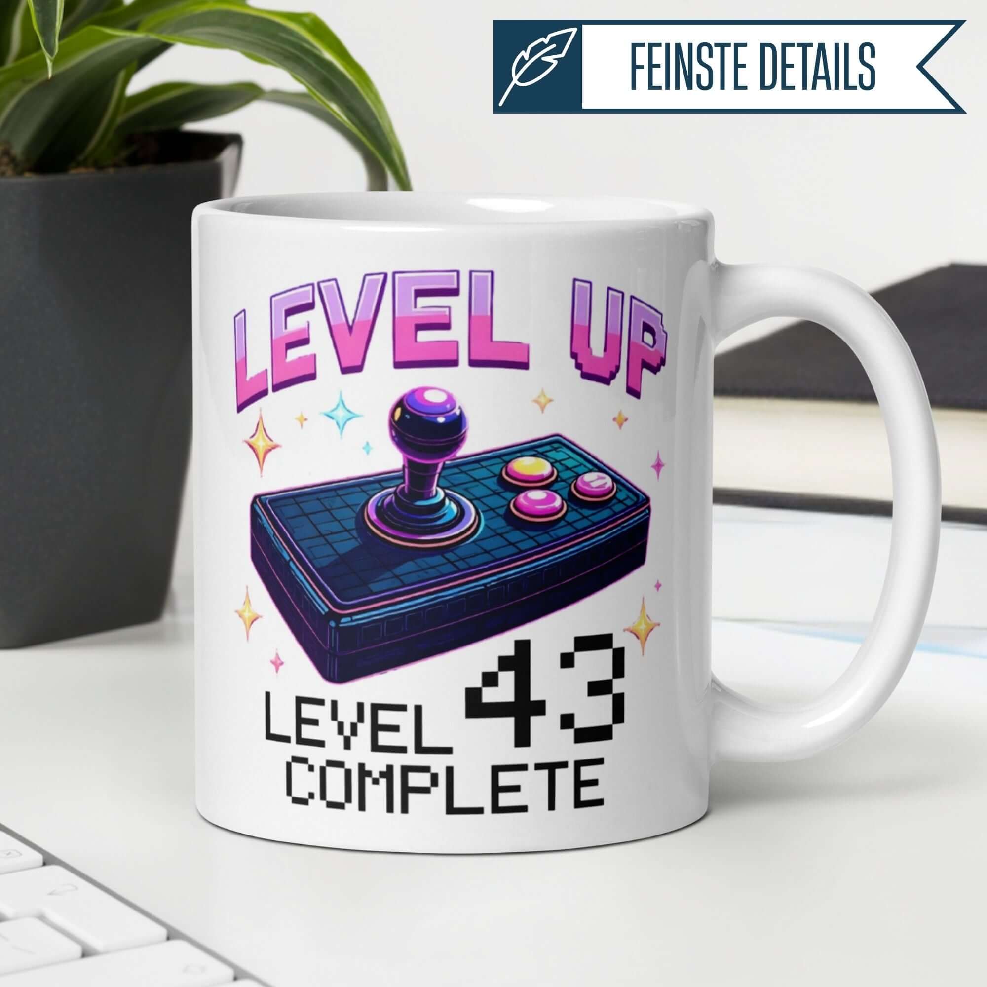 White mug featuring a colorful joystick design with 'Level Up' and 'Level 43 Complete' text for gamers.